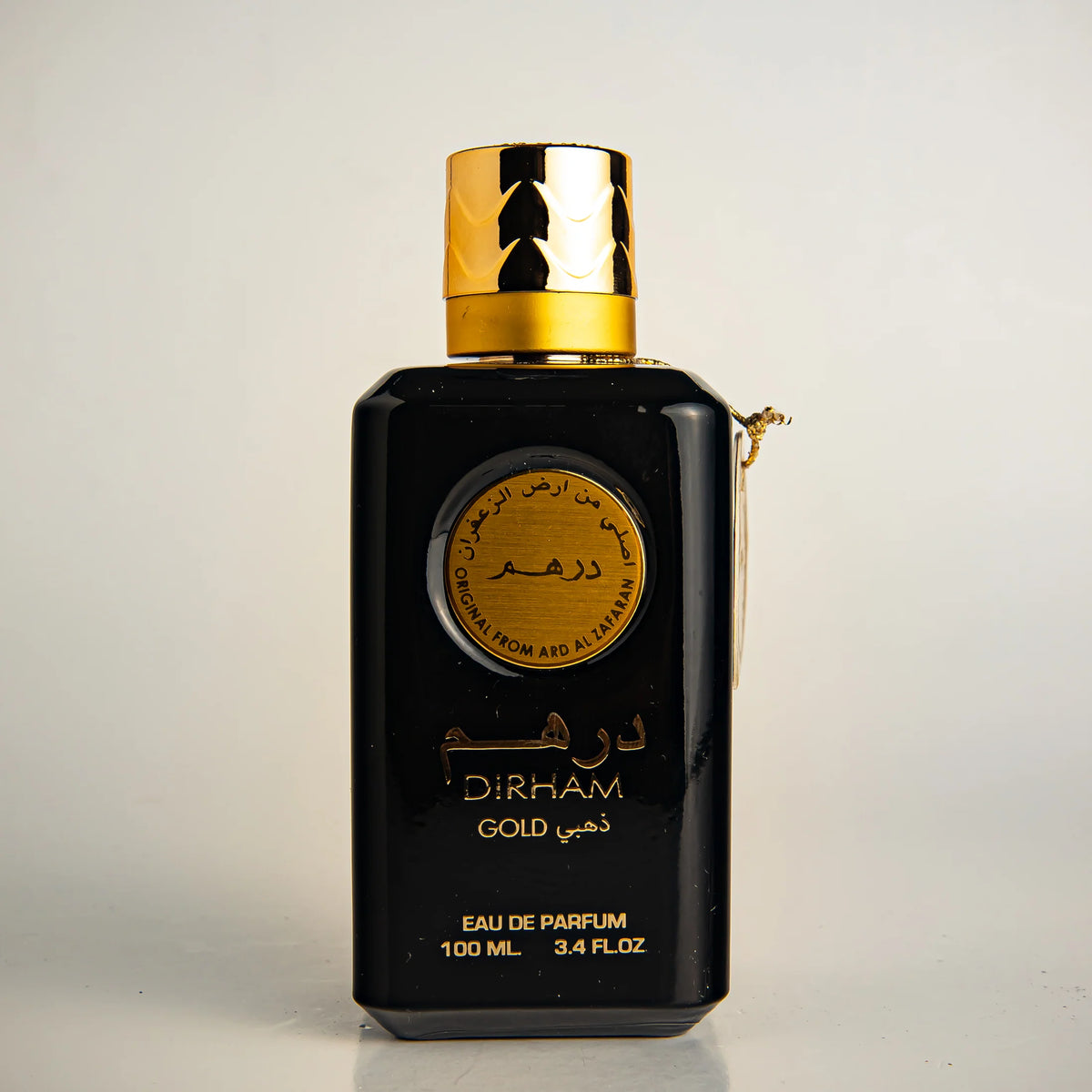 Dirham perfume bottle – rich oriental scent with oud and rose highlights.