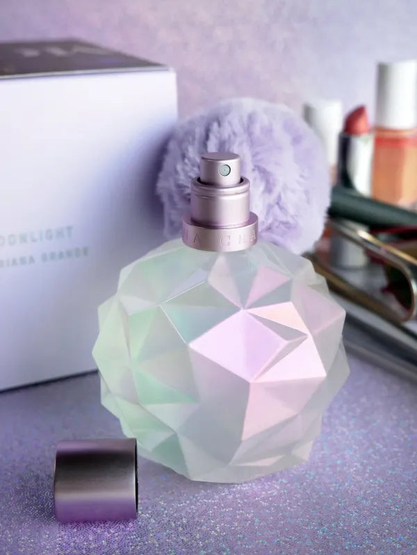 Ariana Grande Moonlight Eau de Parfum in a prismatic bottle with signature puff.
