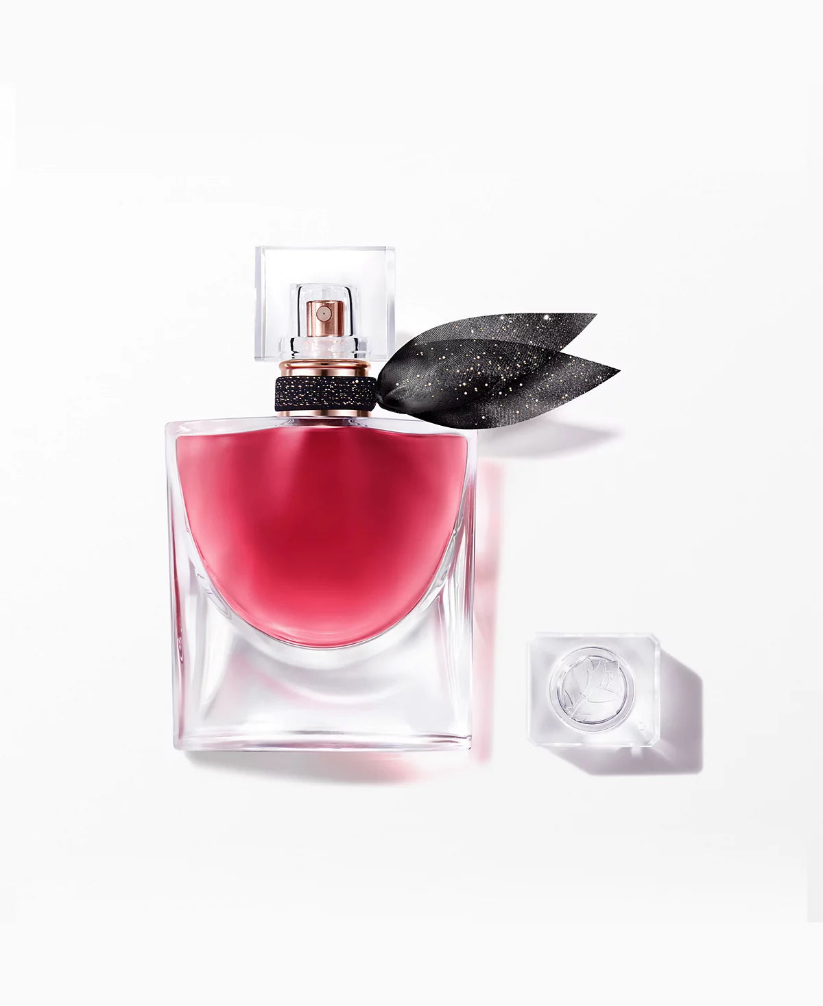 Light perfume bottle with gold details on white background
