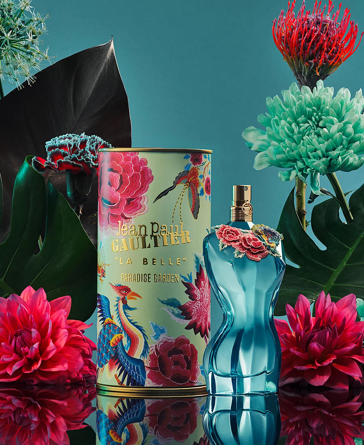 Jean Paul Gaultier La Belle Paradise Garden perfume with colorful packaging against a floral background